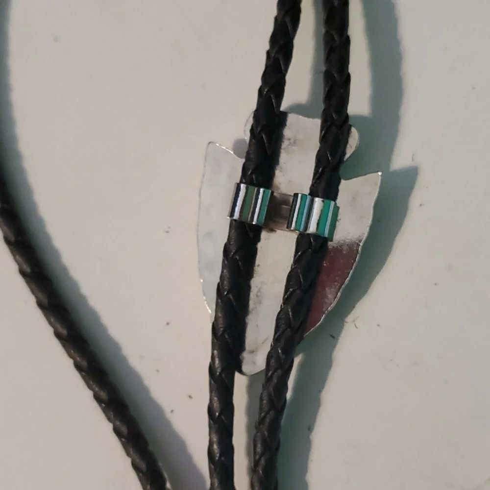 Western Bolo silver tone arrowhead with Turquoise syone on a black bread…